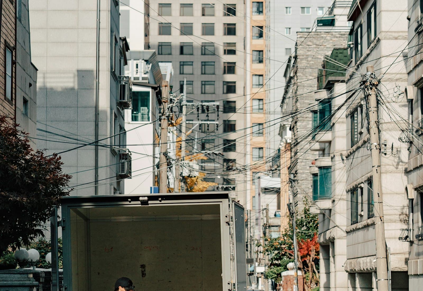 A worker unloading boxes from the back of a delivery lorry